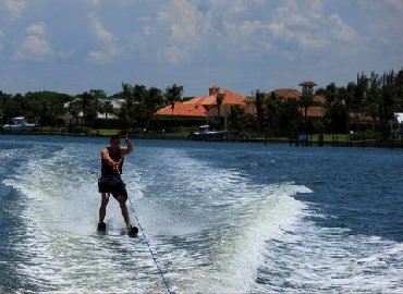 The Book of Rah author Monty Strong giving a thumbs up while water skiing.